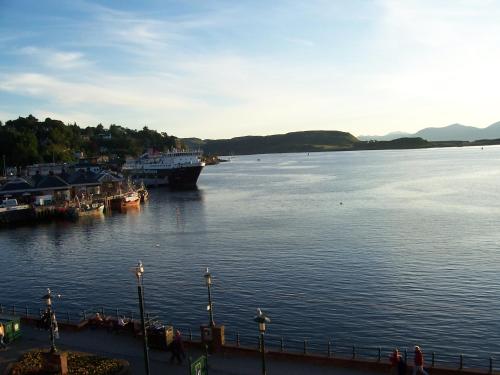 a large boat is docked in a large body of water at Kings Arms Holiday Apartments in Oban