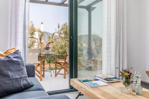 a living room with a couch and a table at Marani Home & Villas in Skopelos Town