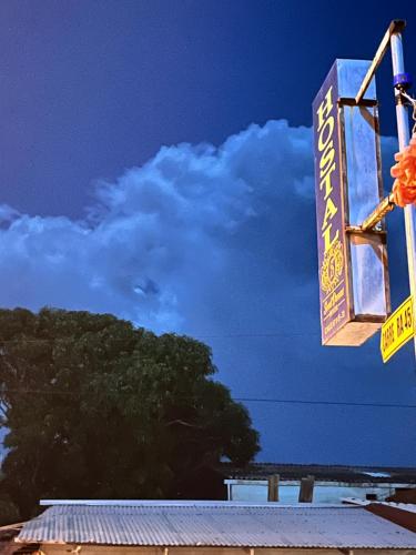 a sign on a building with a blue sky at Sweet Dreams Necocli in Necoclí