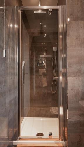 a shower with a glass enclosure in a bathroom at YR HEN FICERDY in Aberystwyth