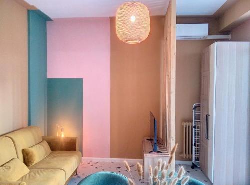 - un salon avec un canapé et un mur coloré dans l'établissement Résidence Le Lérins, à Juan-les-Pins