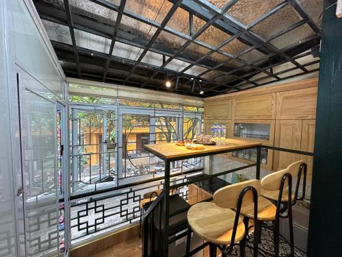 a room with a table and chairs and a window at Center of Old Quarter, K Home, 1 minute to Hoan Kiem Lake in Hanoi
