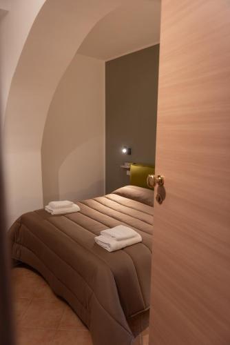 a bedroom with two beds with folded towels on them at La Casetta di Giorgio in Siculiana