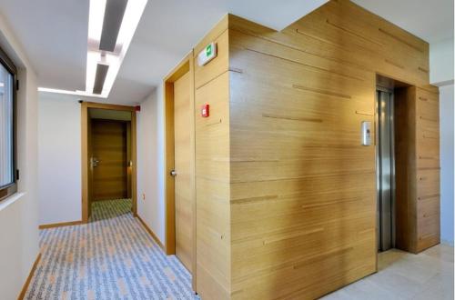 a hallway of an office with a wooden wall at Galaxy City Center Hotel in Patra