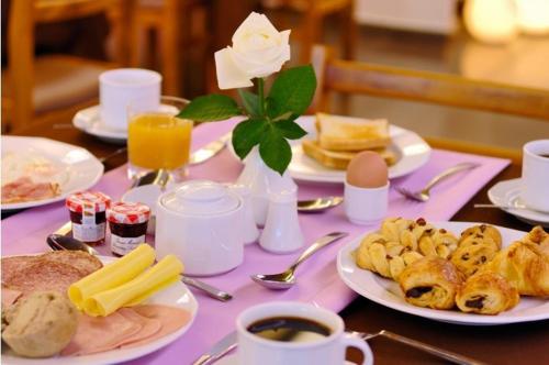 a table with plates of food and eggs and bread at Galaxy City Center Hotel in Patra