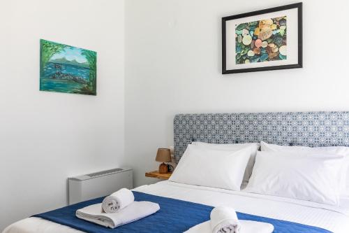 a bedroom with a bed with towels on it at Marani Home & Villas in Skopelos Town