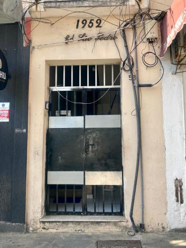 a door in a building with a sign on it at CasAMARelo Hostel in Salvador