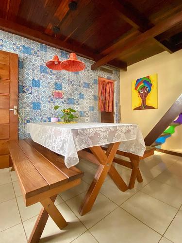 a wooden table with a white cloth on top of it at CasAMARelo Hostel in Salvador