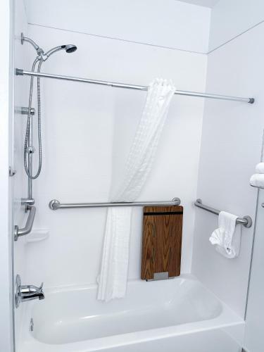 a white bathroom with a shower and a sink at Country Inn & Suites by Radisson, Bloomington-Normal Airport, IL in Bloomington