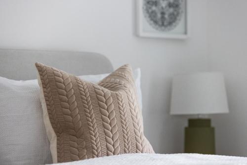 a bedroom with a bed with a pillow and a lamp at The Wagon Shed in Sowerby Bridge