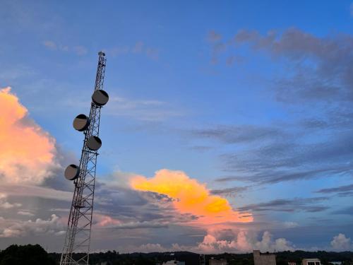 a cell phone tower in front of a cloudy sky at Sweet Dreams Necocli in Necoclí