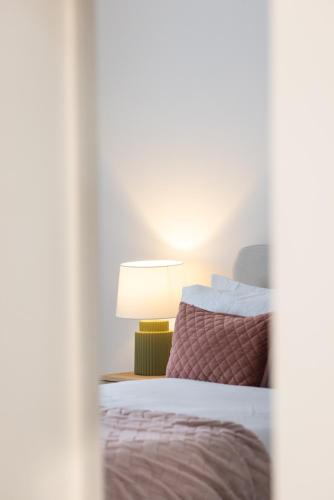 a bedroom with a bed with a lamp next to it at The Wagon Shed in Sowerby Bridge