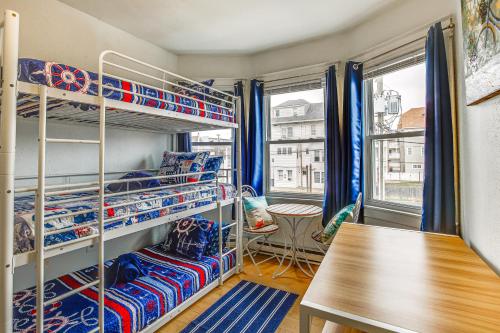 a room with two bunk beds and a table at Family-Friendly Ocean City Condo Walk to Beach! in Ocean City