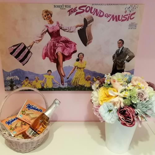 a bottle of beer and a basket of flowers and a poster at Alpenblumal in Bad Goisern