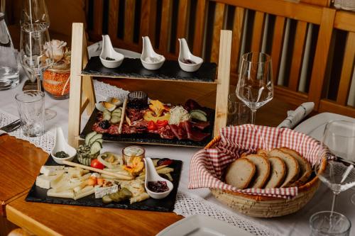 a table with three plates of food and a basket of bread at Weingut Sternat vlg. Schmalzpeter in Arnfels