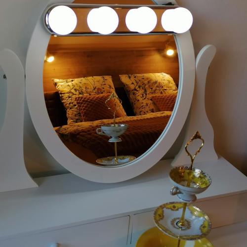 a mirror reflecting a bed in a room at Alpenblumal in Bad Goisern