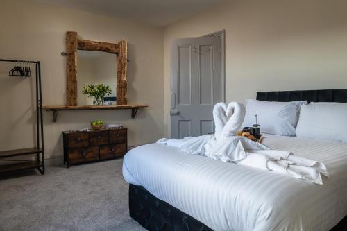 a bedroom with a bed with a swan decoration on it at Orme Lodge in Llandudno