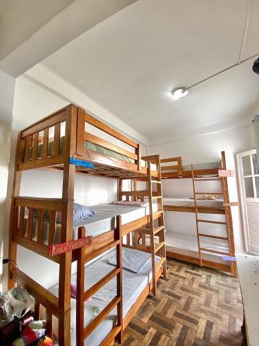a room with four bunk beds in a room at CasAMARelo Hostel in Salvador
