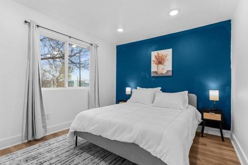 Un dormitorio con una cama grande con una pared azul. en Modern Apartment in downtown dallas 2bed 2 bath, en Dallas