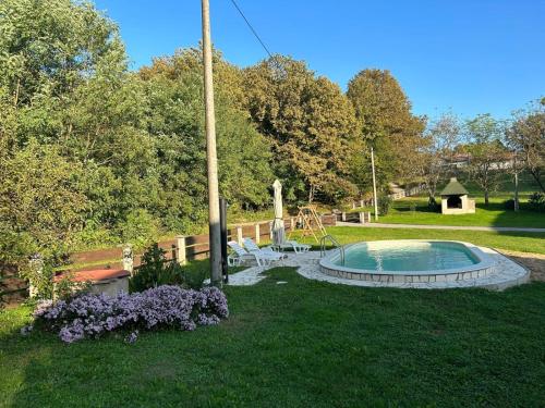 a yard with a swimming pool and a playground at Kuća za odmor Mažuran in Karlovac