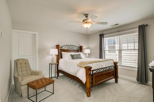 a bedroom with a bed with a ceiling fan and a chair at Updated Greenville Home with Deck about 1 Mi to Downtown in Greenville