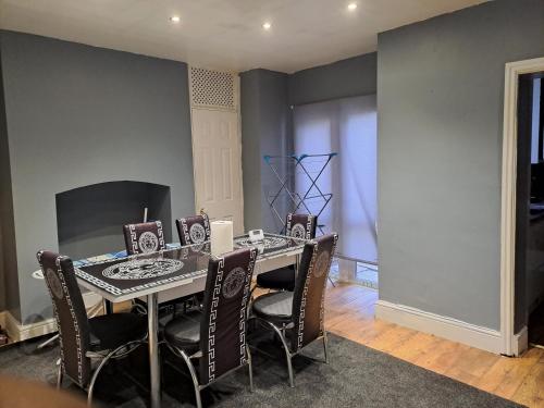 a dining room with a table and chairs at Stunning 3-Bed House in Manchester in Manchester