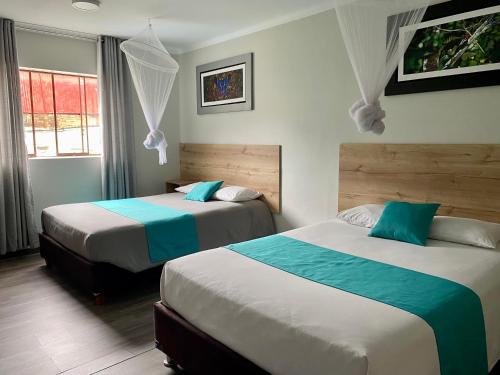 a bedroom with two beds and a window at Casa Plaza Bolívar in Quillabamba