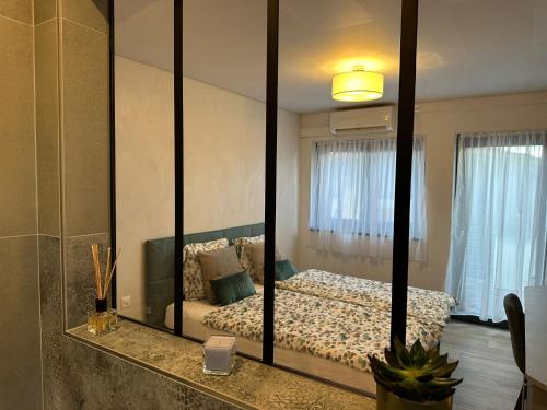 a bedroom with a bed and a large mirror at All'eau Turquoise 