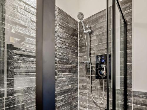 a shower in a bathroom with a stone wall at 1 Bed in Northwich 1.8mi 91435 in Northwich