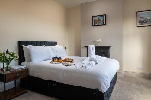 a bedroom with a large bed with towels on it at Orme Lodge in Llandudno
