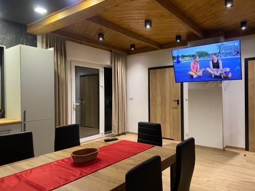 a conference room with a table and a large screen at Leśny Zakątek in Poronin