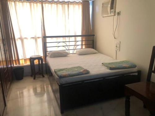 a bed in a room with a large window at Sealink view Apartment next to Hinduja Hospital in Mumbai