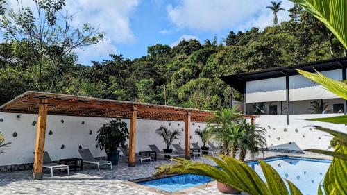 a resort with a swimming pool and a villa at Las Terrazas de Dana Boutique Lodge & Spa in Mindo