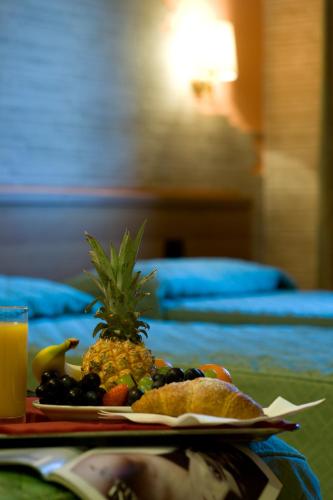 a plate of food with a pineapple on a table at Hotel Ristorante Tre Leoni in Somma Lombardo