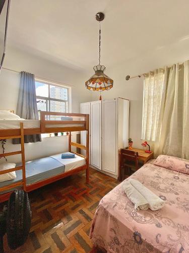a bedroom with two bunk beds and a lamp at CasAMARelo Hostel in Salvador