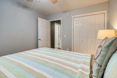 a bedroom with a bed and a lamp and doors at Walkable Wilmington Home Less Than 1 Mi to Waterfront in Wilmington