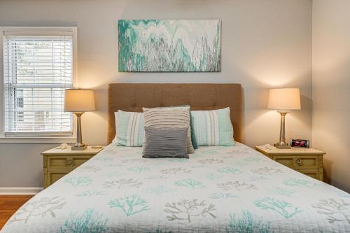 a bedroom with a bed with two night stands and two lamps at Walkable Wilmington Home Less Than 1 Mi to Waterfront in Wilmington