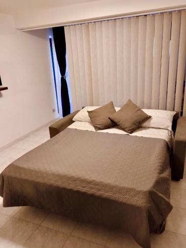 a large bed in a room with a window at LA CASA IN COLLINA in Veroli