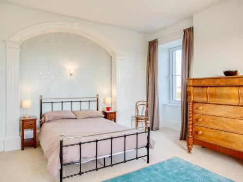 a bedroom with a large bed and a dresser at 3 bed property in Castletown CA416 in Castletown