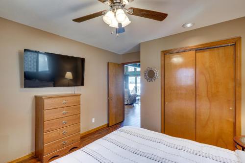 a bedroom with a bed and a flat screen tv at Retreat with Dock and Views in Lake of the Ozarks in Laurie