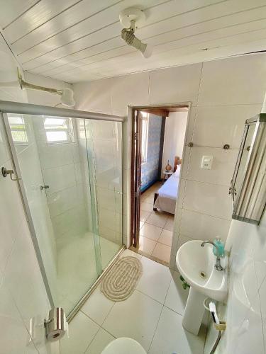 a bathroom with a shower and a toilet and a sink at CasAMARelo Hostel in Salvador