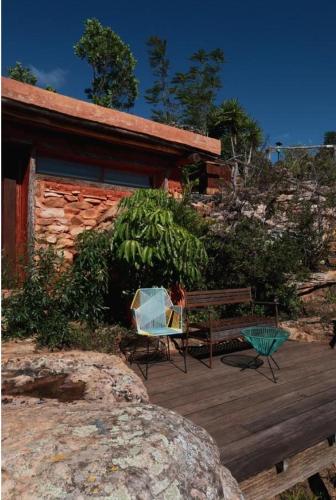 a wooden deck with a bench and a chair at REFUGIO LA ROCA in Los Santos