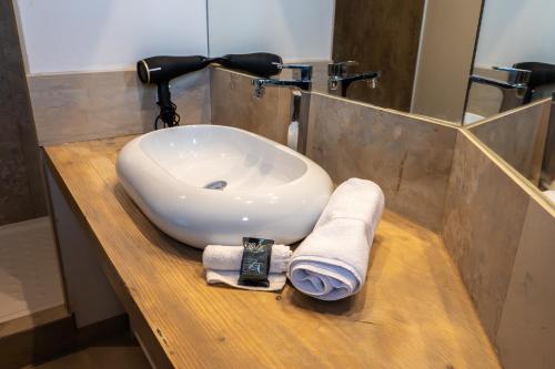 a bathroom sink with a towel on a wooden counter at Les 3 Monts - vue panoramique sur les montagnes in Annecy