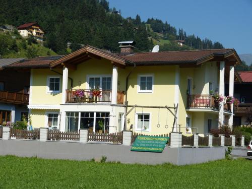 a large yellow house with a sign in front of it at Appartement Millennium in Bad Gastein