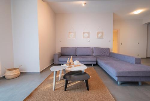 a living room with a couch and a table at Bellevue Villas with private pool in Hanioti
