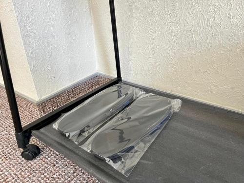 a plastic container sitting on the floor next to a wall at 4Room Hostel in Kyiv