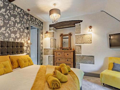 a bedroom with a large bed with yellow pillows at 3 Bed in Lanhydrock 90217 in Bodmin