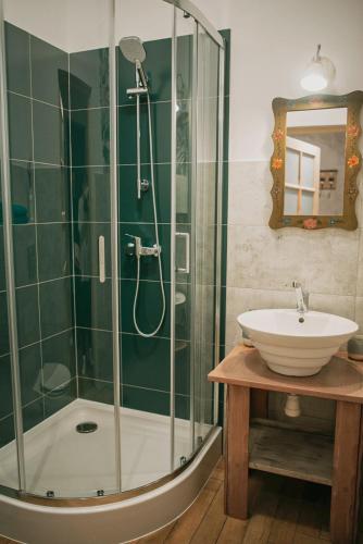 a bathroom with a glass shower and a sink at Lawendowy Raj in Pilchowice