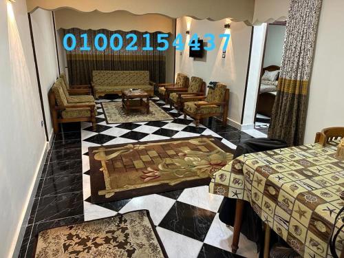a room with two beds and a checkerboard floor at شقه عائليه قريبه من جميع الخدمات in Port Said
