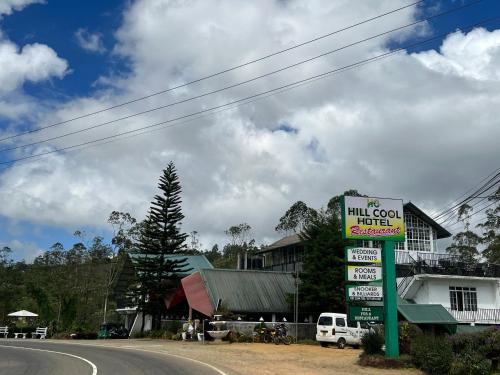 a sign for a hill covenant hotel on the side of a road at Hill Cool Hotel & Restaurant in Hatton